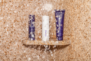  Three toiletries bottles on a shower rack